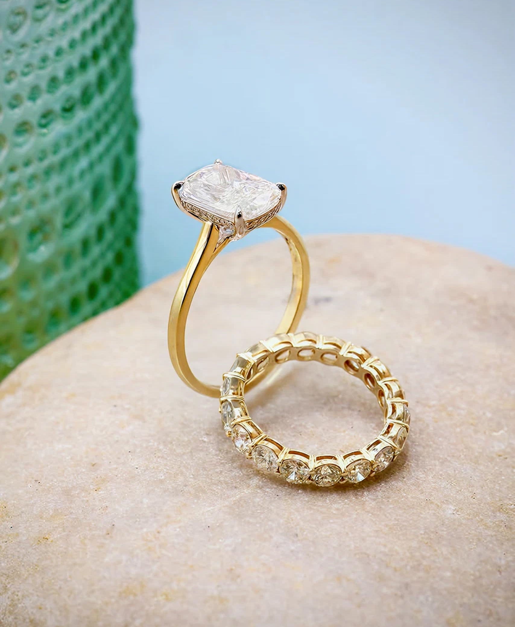 Gold ring with a diamond on a stone surface